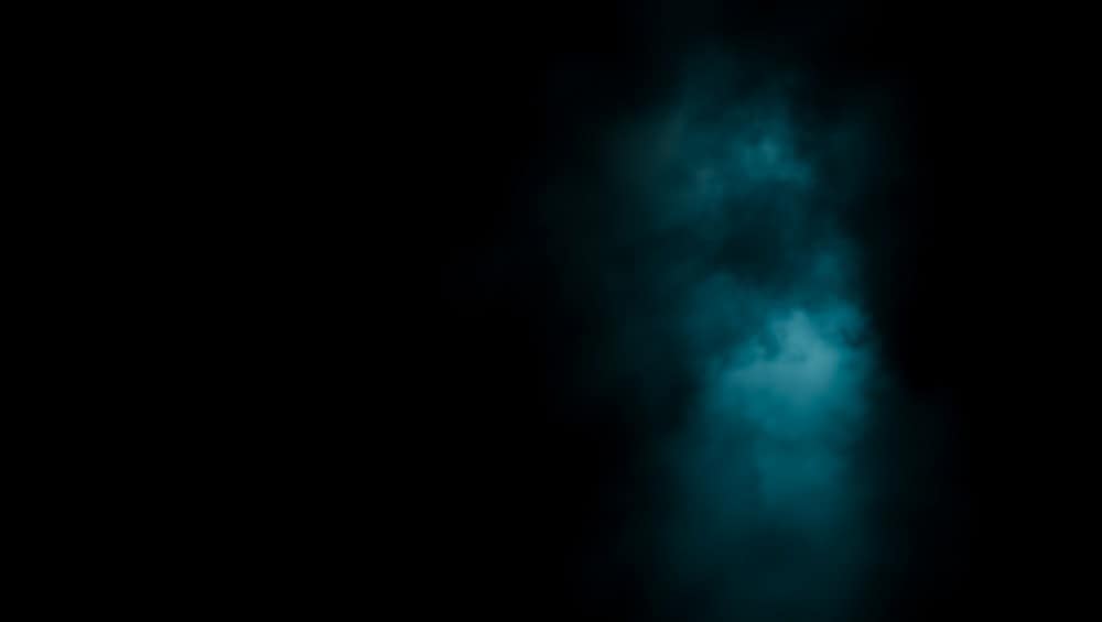 Mysterious blue mist on dark background with glowing effect