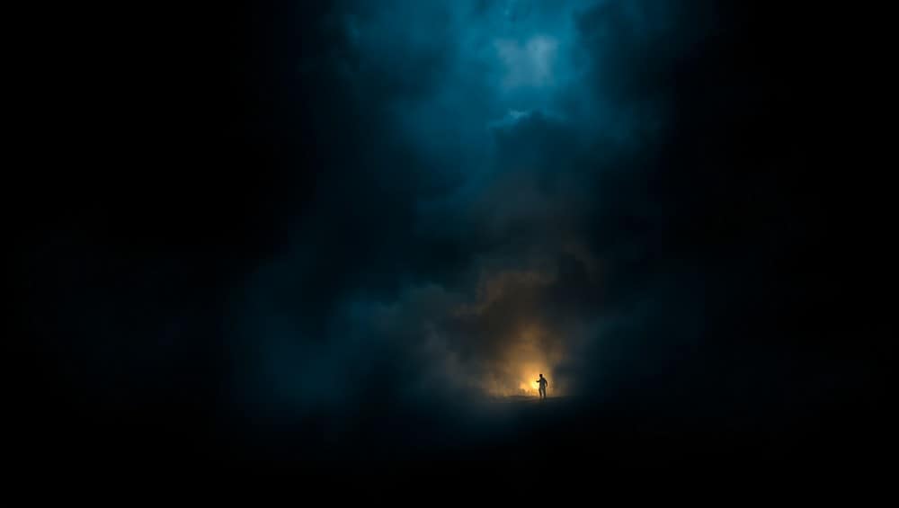 The background of Person a standing alone in mysterious fog with light