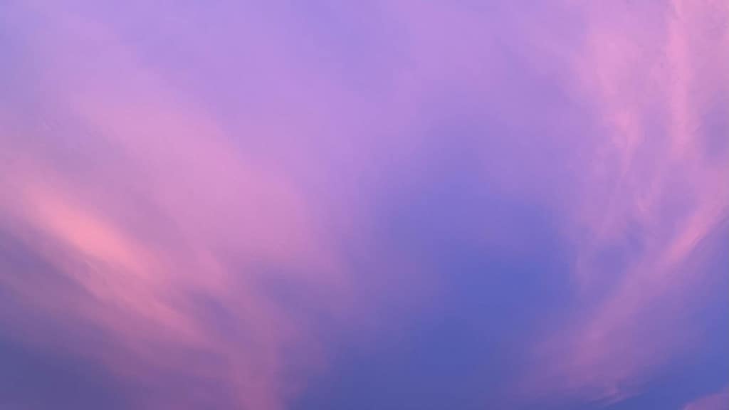 Soft pink and purple sky gradient background with subtle cloud texture