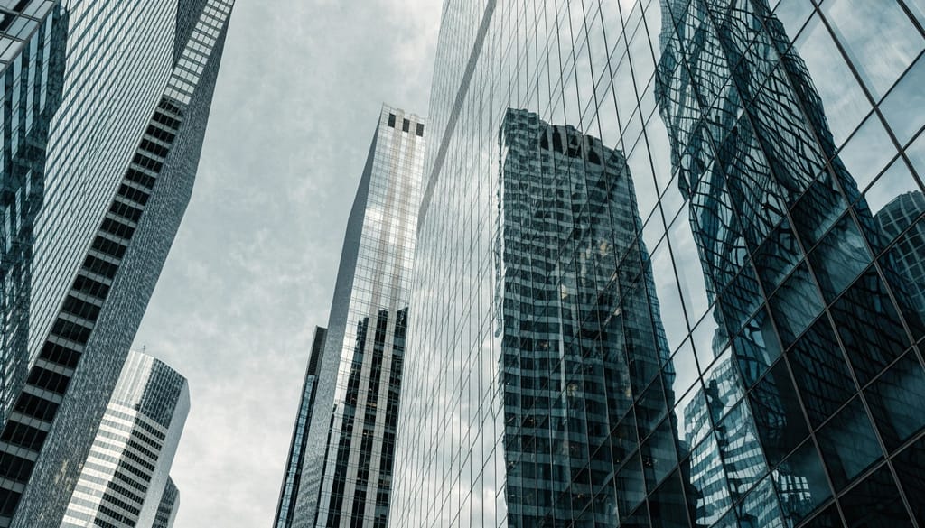 Low angle view of modern glass skyscrapers reflecting a corporate city skyline
