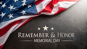 American flag draped elegantly on a dark textured surface with Memorial Day text
