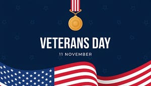 Veterans Day background featuring a gold military medal, text 11 November, and a waving American flag
