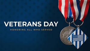Veterans Day graphic background featuring military medals with red white blue ribbons on a dark blue star patterned background.