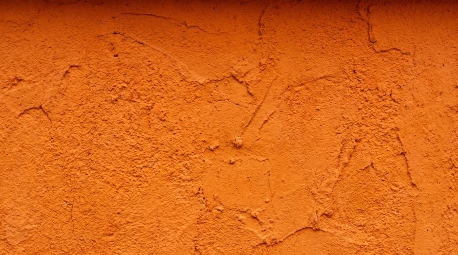 High-resolution rough orange concrete wall texture with plaster details